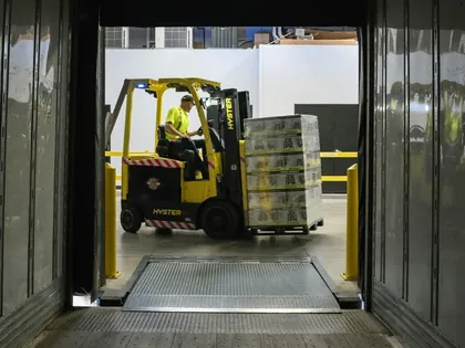 Chariot élévateur chargeant des palettes dans un camion